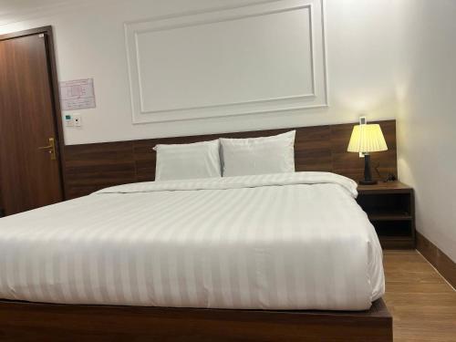 Postel nebo postele na pokoji v ubytování Sapa Warm Hotel