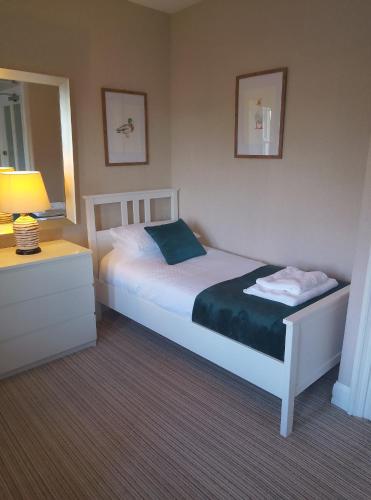 a bedroom with a bed and a lamp and a mirror at Barrasford Arms in Hexham