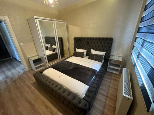 a bedroom with a large bed and a mirror at EF Otel in Yeşilkent
