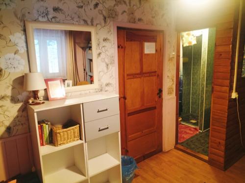 a room with a mirror and a shelf and a door at Willa 7 in Korbielów