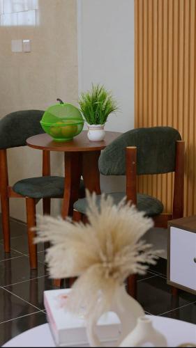 a table with two chairs and a green bowl on it at GNj HOMES in Sisa