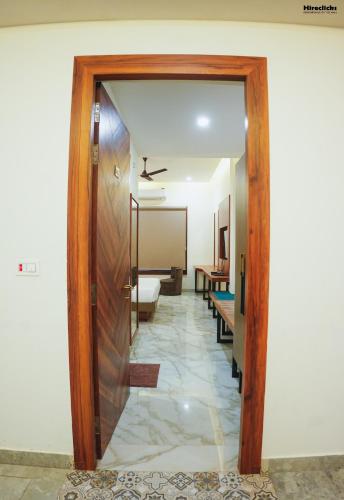 a door leading into a room with a hallway at The Krati Resort & Convention Centre in Bareilly