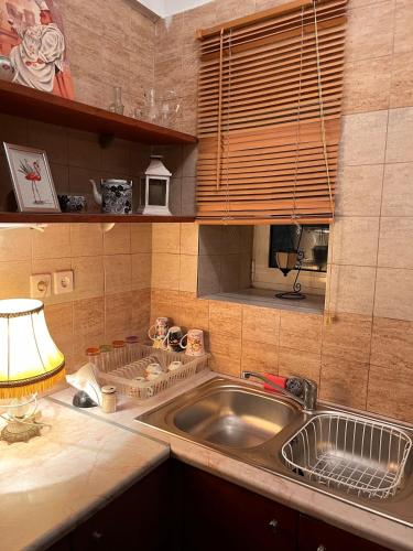 a kitchen with a sink and a lamp on a counter at Azure Loft in Rodhiá