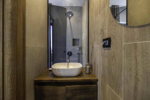 a bathroom with a white sink on a wooden counter at Chalet 1600 Kopaonik in Kopaonik