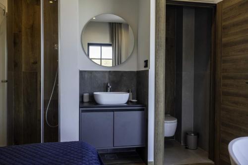 a bathroom with a sink and a mirror at Chalet 1600 Kopaonik in Kopaonik