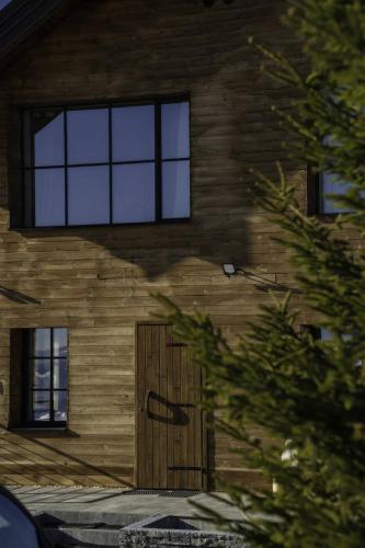a building with a wooden door and windows at Chalet 1600 Kopaonik in Kopaonik