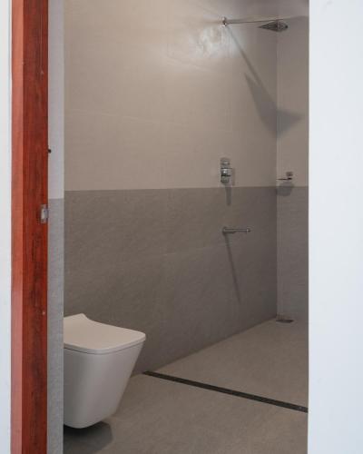 a bathroom with a toilet and a shower at Elora Plantation Villa By Cluster cloud in Idukki