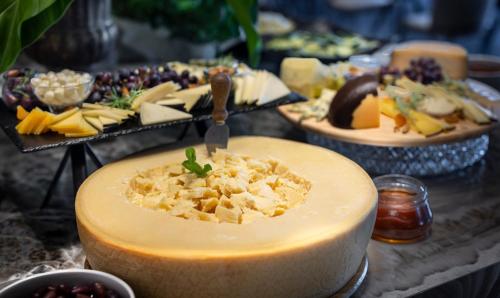 a table topped with cheese and other appetizers at Grand Hotel Adriatic in Opatija