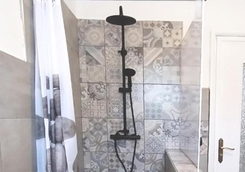 a shower in a bathroom with a tile wall at Appartamento ZOIA in Crevacuore