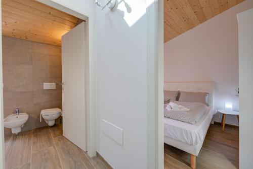a bedroom with a bed and a toilet and a sink at Casa del sole in Arco