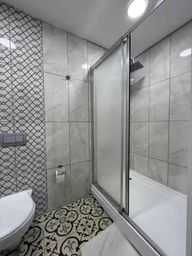 a bathroom with a shower and a toilet and a tub at Grand Bedir in Istanbul