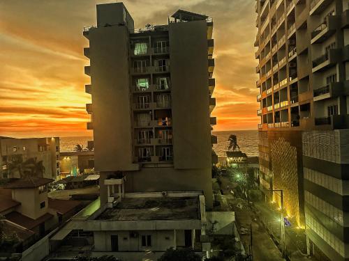 a view of a building with a sunset in the background at Beach Symphony in Mount Lavinia