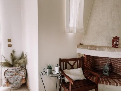 a living room with a chair and a fireplace at Theonia Villas in Pefki Rhodes
