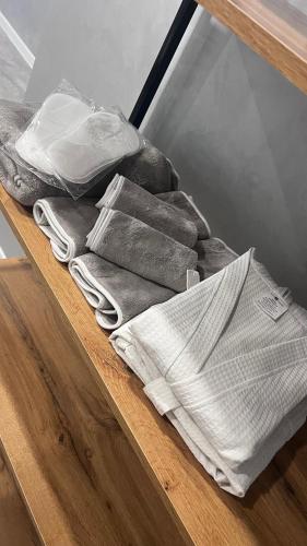 a pile of towels sitting on top of a table at Новая квартира в минуте от Мечети, Достыка, Самовара, Coffee Boom , Хуторка, Прокуратуры, Налоговой, Акимат города, ЦУМа in Petropavlovsk