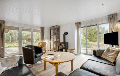 a living room with a couch and a table at Holiday Home Kirstinevej Hvide Sande V in Bjerregård