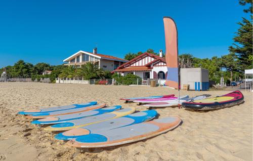a row of surfboards lined up on the beach at Beautiful Home In Ares in Arès