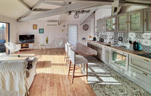 a kitchen with a table and chairs in a room at Beautiful Home In Ares in Arès