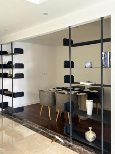 a dining room with a table and chairs at D’Leroi Soleil - Westlake Suite & Apartment in Hanoi