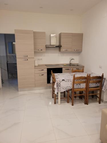 a kitchen with a table and two chairs with a dog on it at Casa Amelia in Rapallo