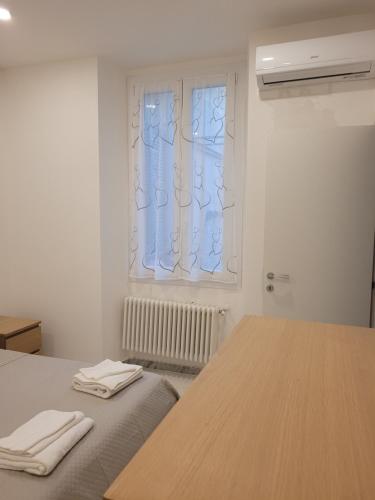 a white room with a table and a window at Casa Amelia in Rapallo