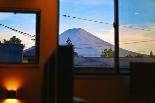 a view of a mountain from a window at リノベーションされた一軒家で富士山と自然 BBQを満喫 villa voyage in Azagawa