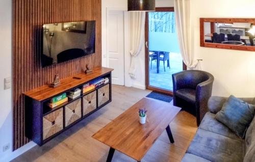 a living room with a tv and a table at Ferienhaus 1 In Kirchheim in Kirchheim