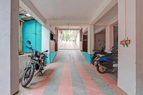two motorcycles parked in the hallway of a building at SPOT ON The New View Regency in Trivandrum