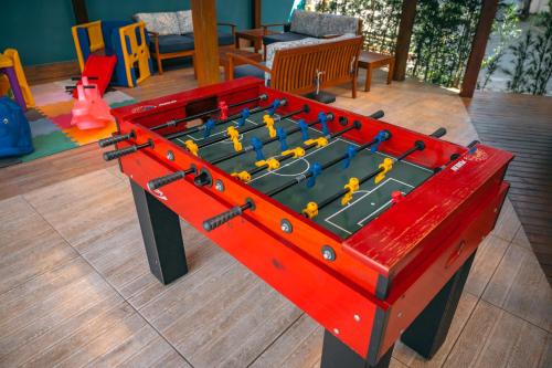 a large red table with toys on top of it at Ayla Praia Hotel Centro Porto Segur in Porto Seguro