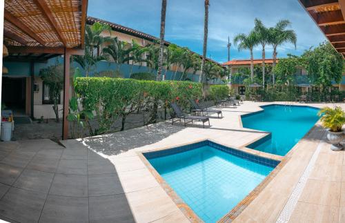 a swimming pool in the middle of a resort at Ayla Praia Hotel Centro Porto Segur in Porto Seguro