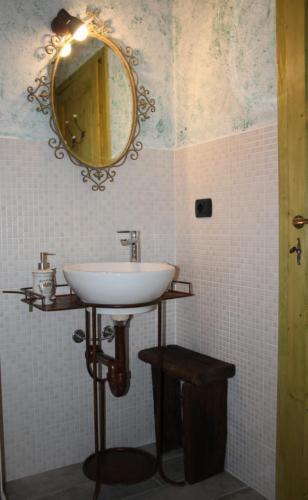 a bathroom with a sink and a mirror on the wall at Azienda Agricola Garoglio Davide in Alfiano Natta