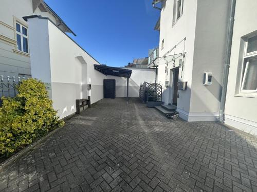 an alley between two white buildings at Pension Wald und See in Ahlbeck
