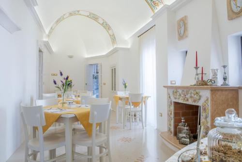 a dining room with a table and a fireplace at Dimora Dell'Osanna in Carovigno