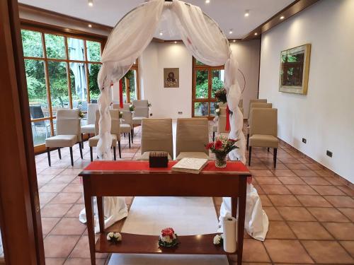a room with chairs and a table with a canopy at Hotel-Restaurant Bibermühle GmbH in Tengen