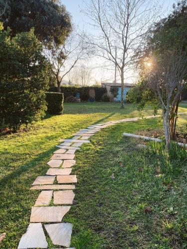a stone path in the grass in a park at Charmant Studio Design Au Calme Avec Piscine in Le Muy
