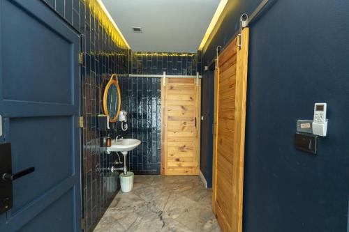 a bathroom with a sink and a blue wall at The Locals Bangkok Old Town in Bangkok