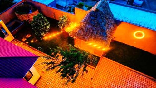an overhead view of a building with palm trees and lights at Safi House in Boma la Ngombe