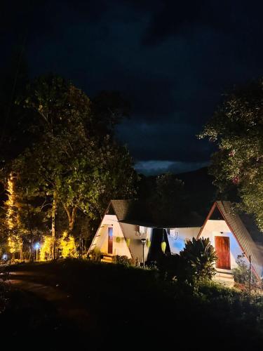 a house at night with the lights on at Forestscape Resort Munnar in Munnar