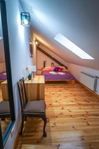 a bedroom with a bed and a desk and a chair at Lawki Booking in Ławki