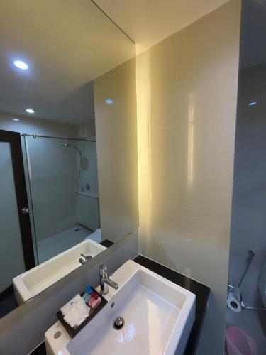 a bathroom with a white sink and a mirror at My PLACE HUA-HIN HOTEL in Hua Hin