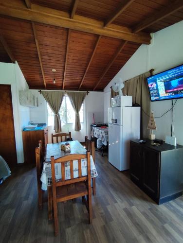 a living room with a table and a refrigerator at Fusión Natural in Playa Verde