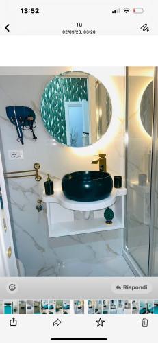 a bathroom with a green sink and a mirror at Alex mary home in Naples