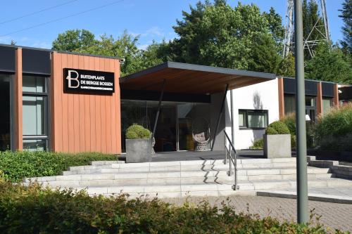 a building with a sign on the front of it at Buitenplaats de Bergse Bossen in Driebergen