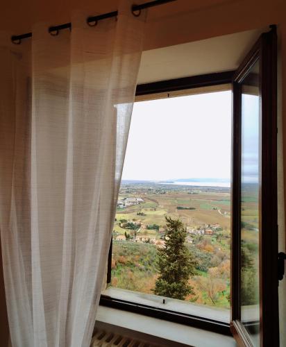 a window with a view of a field at La casa in piazza in Panicale