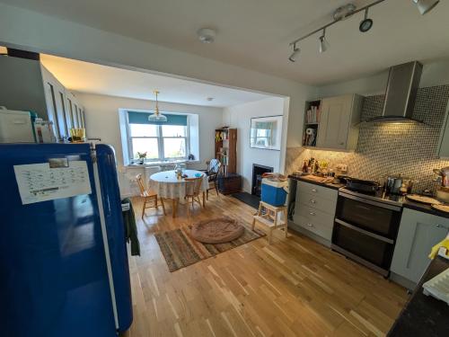 a kitchen with a table and a dining room at Tigh Grianach in Port Charlotte