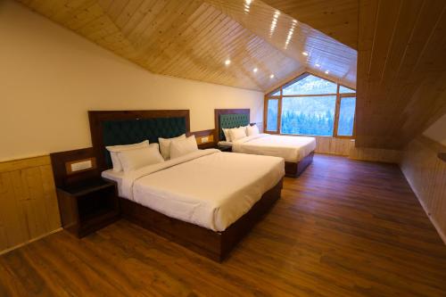 a bedroom with two beds and a window at Hidden Heaven, Near Nature Park in Manāli