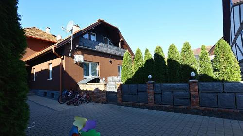 a house with bikes parked next to a fence at Kokavská izba - Apartmány in Kokava na Rimavica