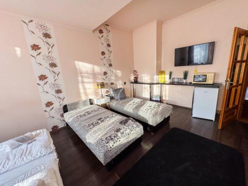 a living room with a couch and a table at Éjjelibagoly Vendégház in Szentes