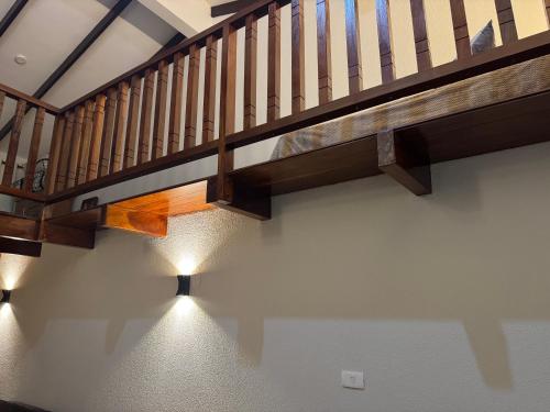 a staircase with wooden railings in a house at Hermosa Cabaña - Centro de Samaipata in Samaipata