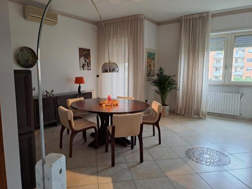 a living room with a dining room table and chairs at 2 Giugno House in Bari
