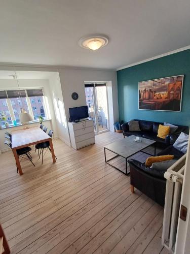 a living room with a couch and a table at Beautiful 3 bedroom apartment in Central City in Aalborg